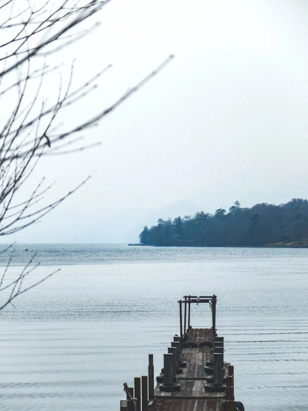A wooden dock on a lake in Nikko Japan