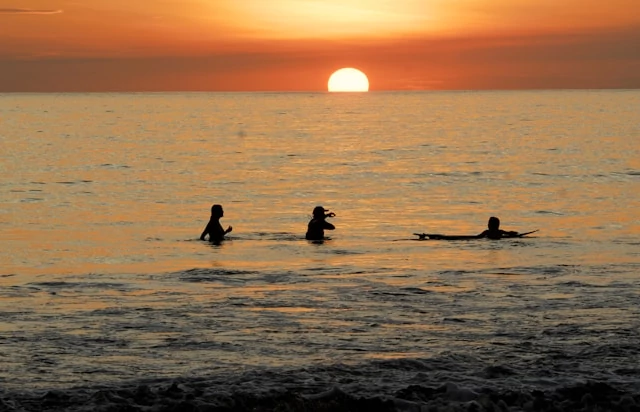 People enjoying the sea and the sunset at Manuel Antonio, Costa Rica People enjoying the sea and the sunset at Manuel Antonio, Costa Rica