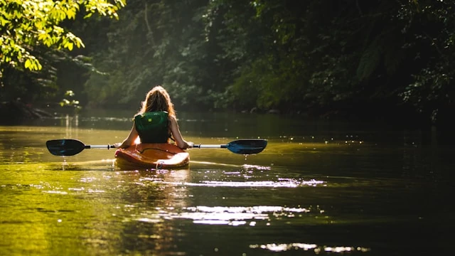 A woman kayaking through Costa Rica A woman kayaking through Costa Rica