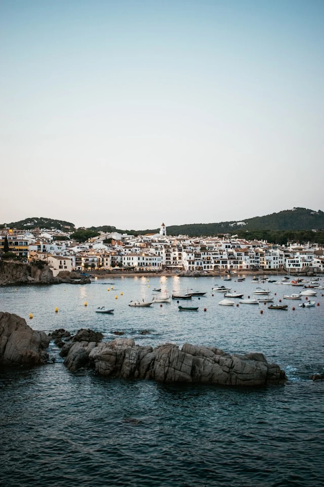 The fishing village of Calella de Palafrugell, characterized by its white houses and its bay full of boats at dusk