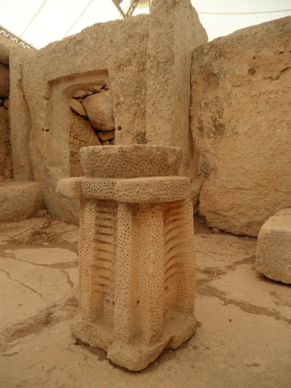 Stone structures of an ancient megalithic temple in Malta, with large weathered limestone blocks.