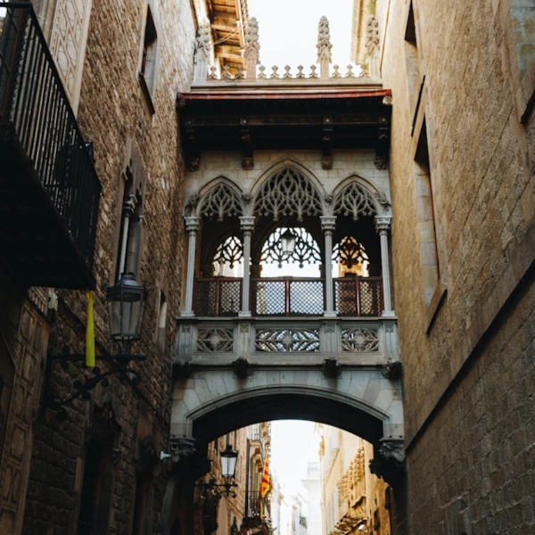 Old archway in between two stone buildings in the gothic quarter of Barcelona