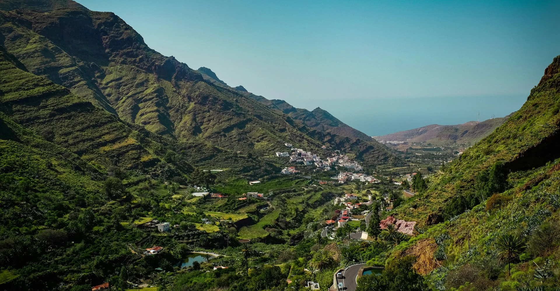 The green valley of Agaete seen from above, with the blue ocean on the background