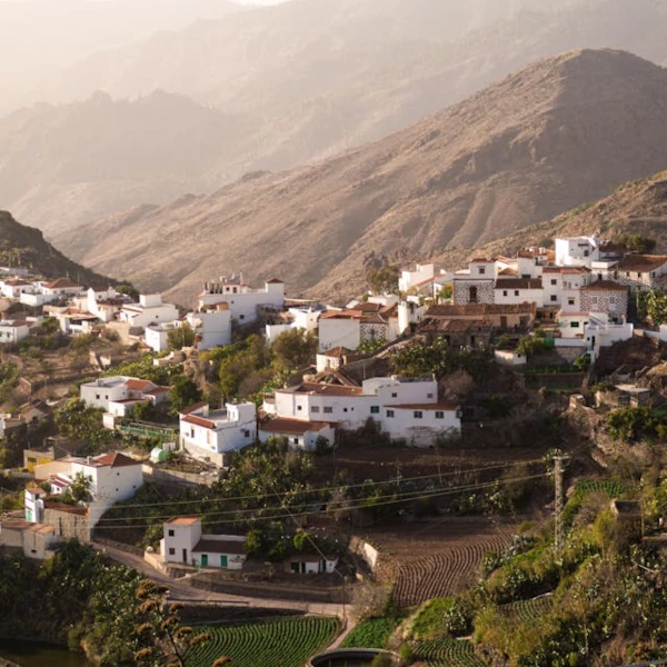 A white village built on a deep ravine of Gran Canaria with views on the distant valleys and ravines far ahead