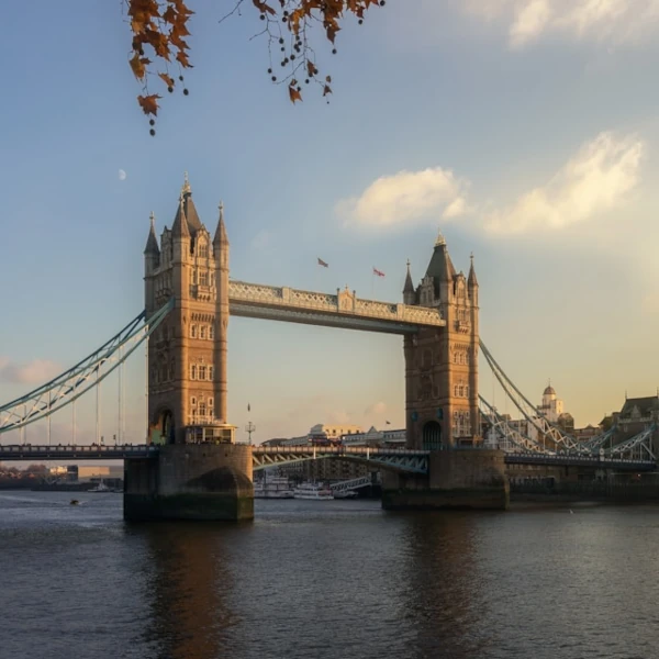 View of Tower Bridge during dusk, with the Thames river flowing beneath