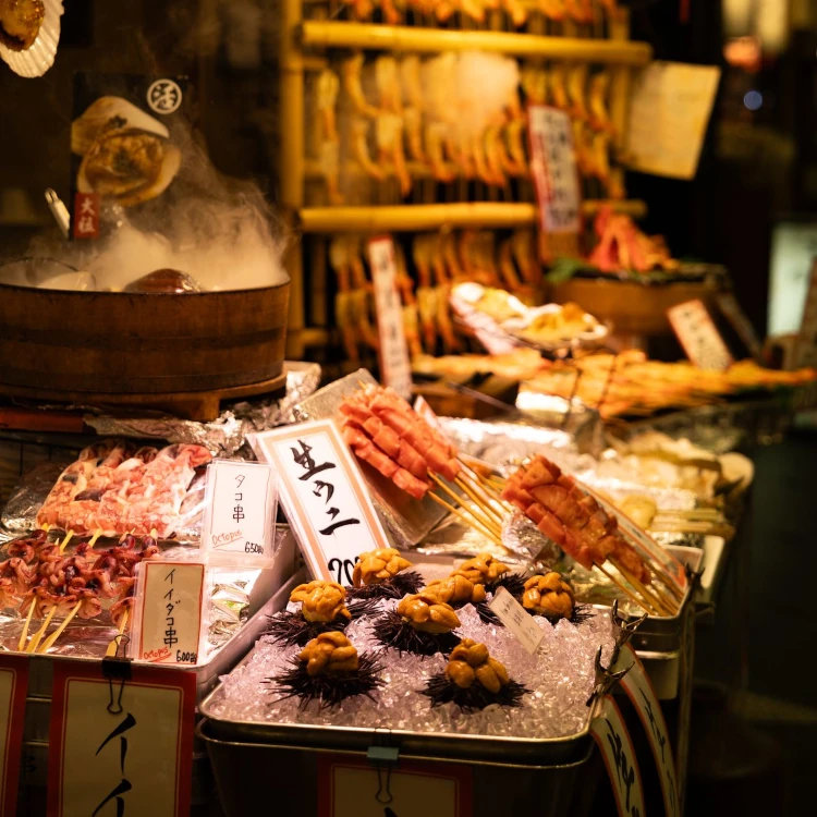 Colorful display of traditional Japanese street food under warm lights.