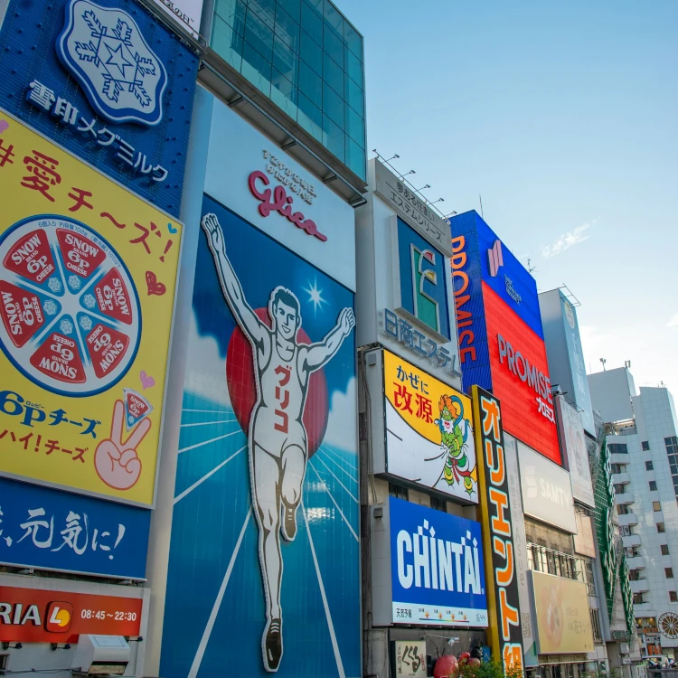 Vibrant advertisements in Dotonbori district, Osaka capturing the lively urban scene with the famous Glico Man sign.