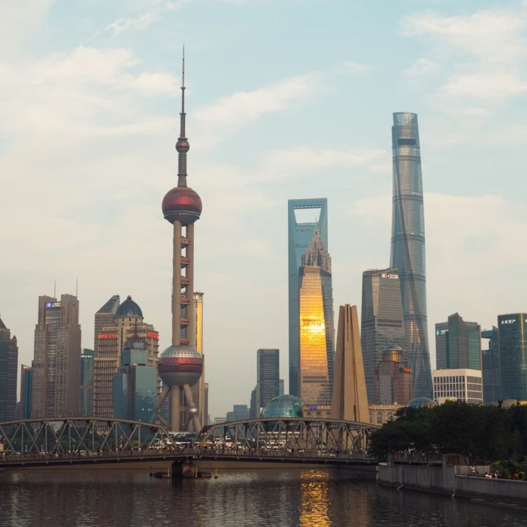 The recognisable towers of Pudong, Shanghai, with a bridge between them and the photographer