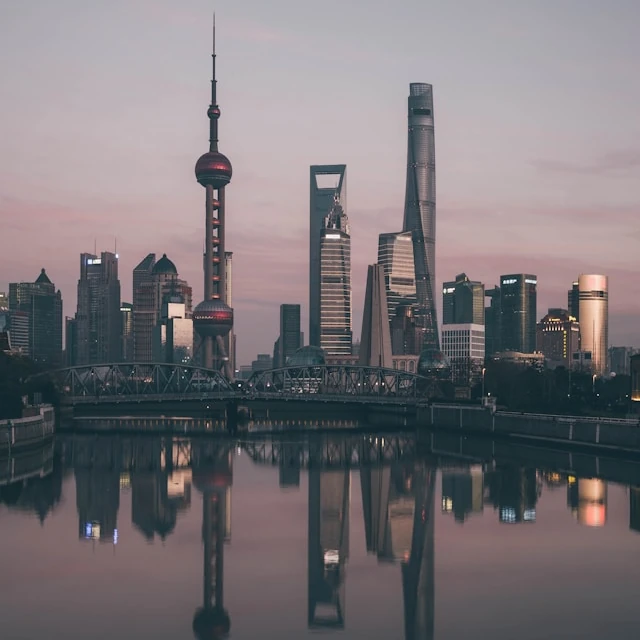 The skyscrapers of Pudong, in Shanghai, reflected in the water in the soft light of dusk