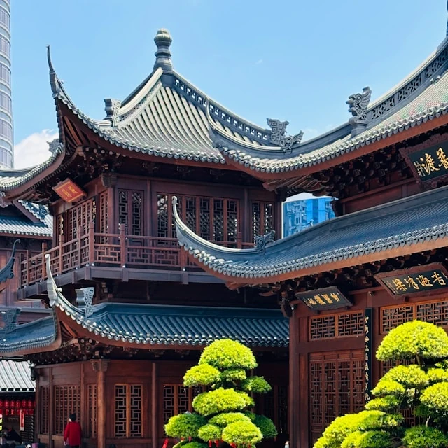 A serene temple complex in China, with dark roofs, dark, ancient wood, and beautiful traditional decorations