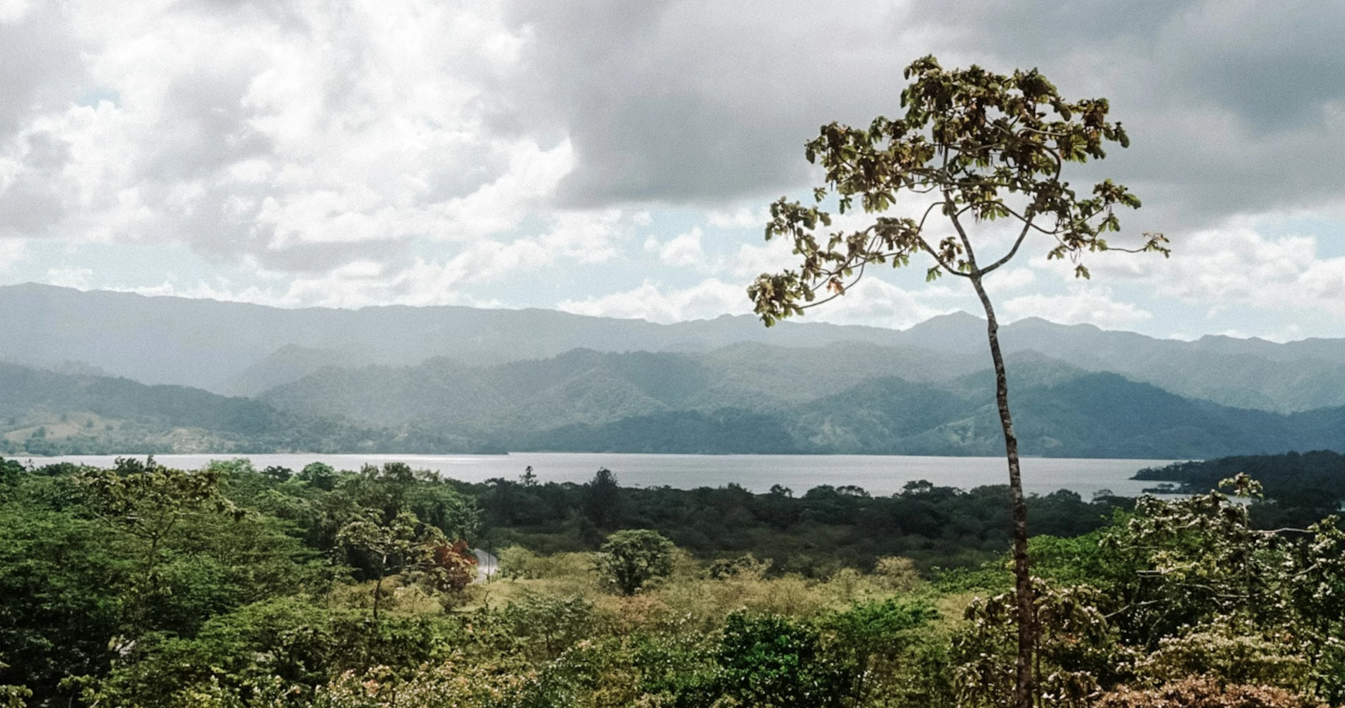 Lake Arenal surrounded by lush green vegetation and mountains