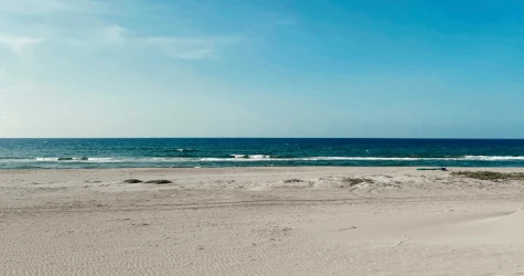 Golden beach in Tela, Honduras, with calm Caribbean waters