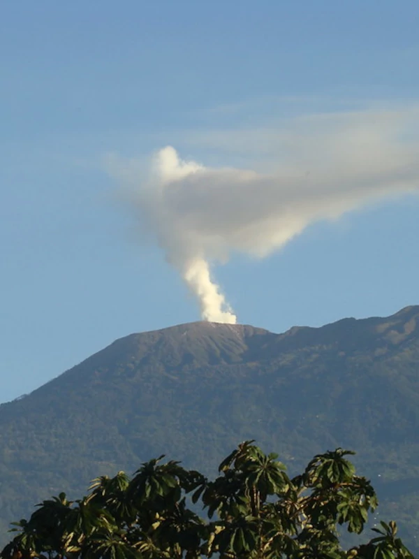 View of Turrialba volcano on the distance ejecting white smoke